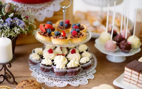 Słodkie przekąski na imprezę: babeczki, tartaletki z owocami, cake pops i ciasto.